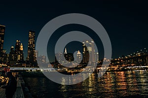 Brooklyn Bridge and panoramic night view of downtown Manhattan after sunset in New York City, USA