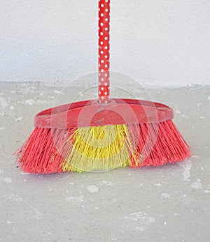 Broom besom on a concrete background