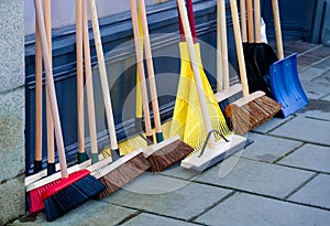 Broom brushes and snow spade for sale displayed outside of hardware shop