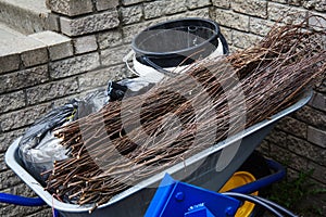 broom for cleaning street in metal wheelbarrow.