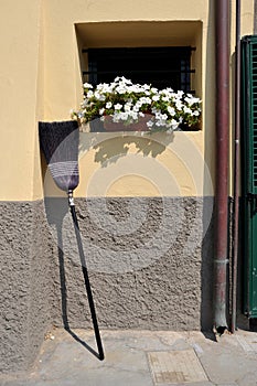 Broom propped against the wall