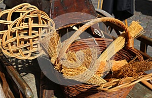 broom of sorghum, carpet beater and wicker containers photo