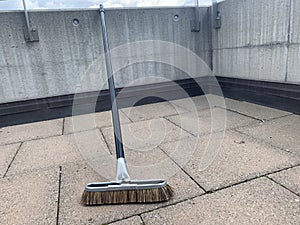 Broom with stick on balcony