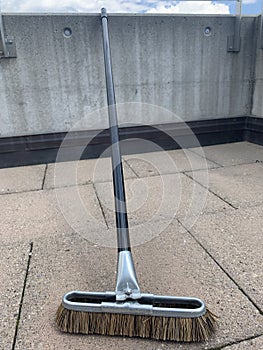 Broom with stick on balcony