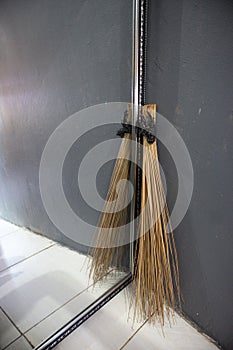 broom stick in the corner of the house with glass