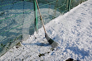 Broom for sweeping snow. Sweep snow with a broomstick.