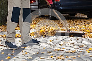 Brooming driveway from leaves