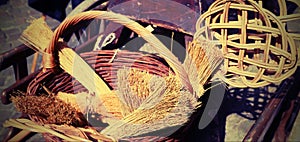 brooms of sorghum, a carpet beater and wicker containers for sal photo