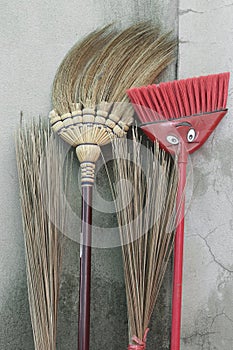 Brooms stick on brick wall