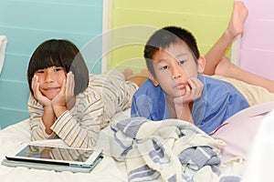 Brother ans sister siblings together on bed