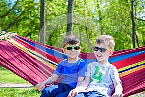 Brother and boy relaxing in hammock at vacation