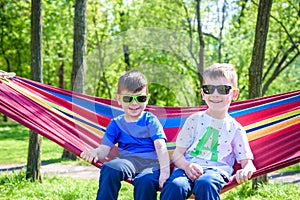 Brother and boy relaxing in hammock at vacation