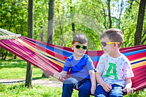 Brother and boy relaxing in hammock at vacation