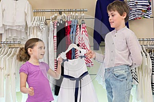 The brother helps sister to choose clothes