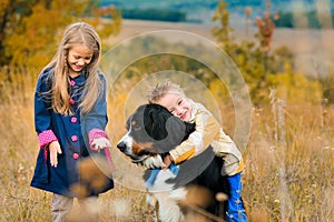 brother and his sister on walk with his four-footed dog friend o