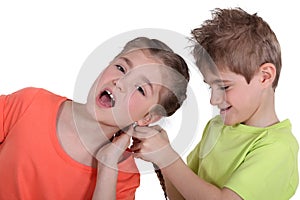 Brother pulling sister's hair