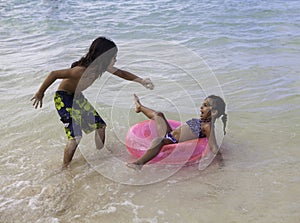 Brother scaring his sister with a crab