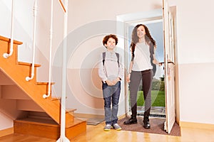 Brother and sister arriving home after school photo