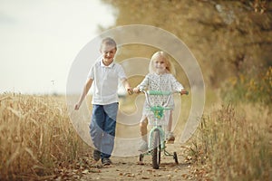 Brother and sister on autumn road