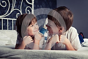 Brother and sister on bed