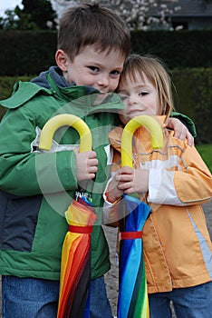 Brother and sister and big umbrellas