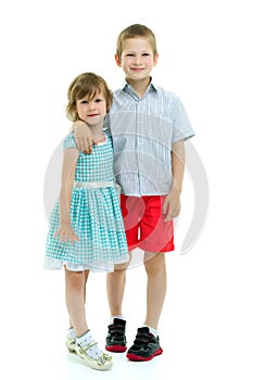 Brother and sister, boy and girl posing in the studio. Friendshi