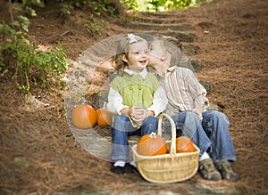 Brother and Sister Children on Wood Steps with Pumpkins Whispering