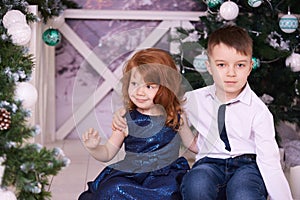 Brother and sister. Christmas interior. Small children. Horizontal