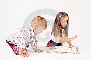 Brother and sister cooking bakery on kitchen