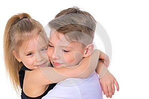 Brother and sister embrace.