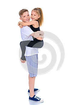 Brother and sister embrace.