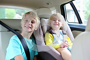 Brother and sister enjoying trip in the car