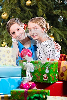 Brother and sister during handing out of presents, wishing Merry