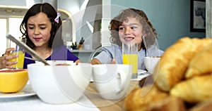 Brother and sister having breakfast