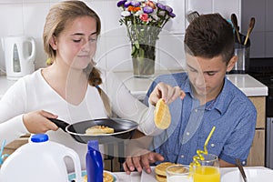 Brother and sister having breakfast