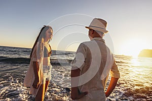 Brother and sister are having fun on the beach.