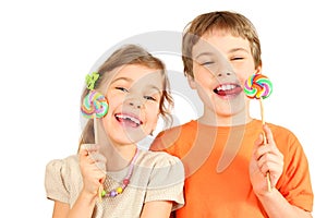 Brother and sister hold lollipops