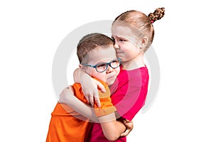 Brother and sister hugging and smiling. Isolated on a white background