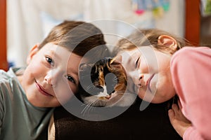 Brother and sister with kitty cat. Children`s love for pets