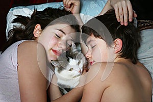 Brother sister lay with cat close up portrait