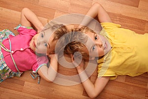 Brother and sister lie on floor