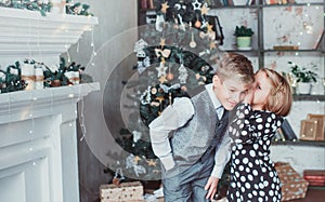 Brother and sister in the living room in the background of the Christmas tree. Children festively dressed