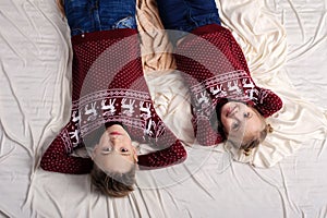 Brother and sister lying on a bed