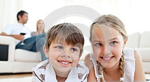 Brother and sister lying on the floor photo