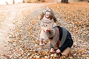 Brother and sister made a break in the autumn forest