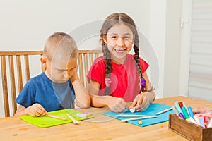 Brother and sister molding at the table