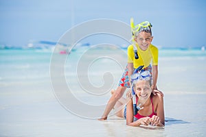 Brother and sister playing on the beach during the hot summer vacation day.