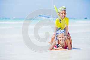 Brother and sister playing on the beach during the hot summer vacation day.