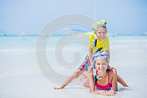 Brother and sister playing on the beach during the hot summer vacation day.