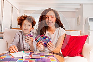 Brother and sister playing card games indoors